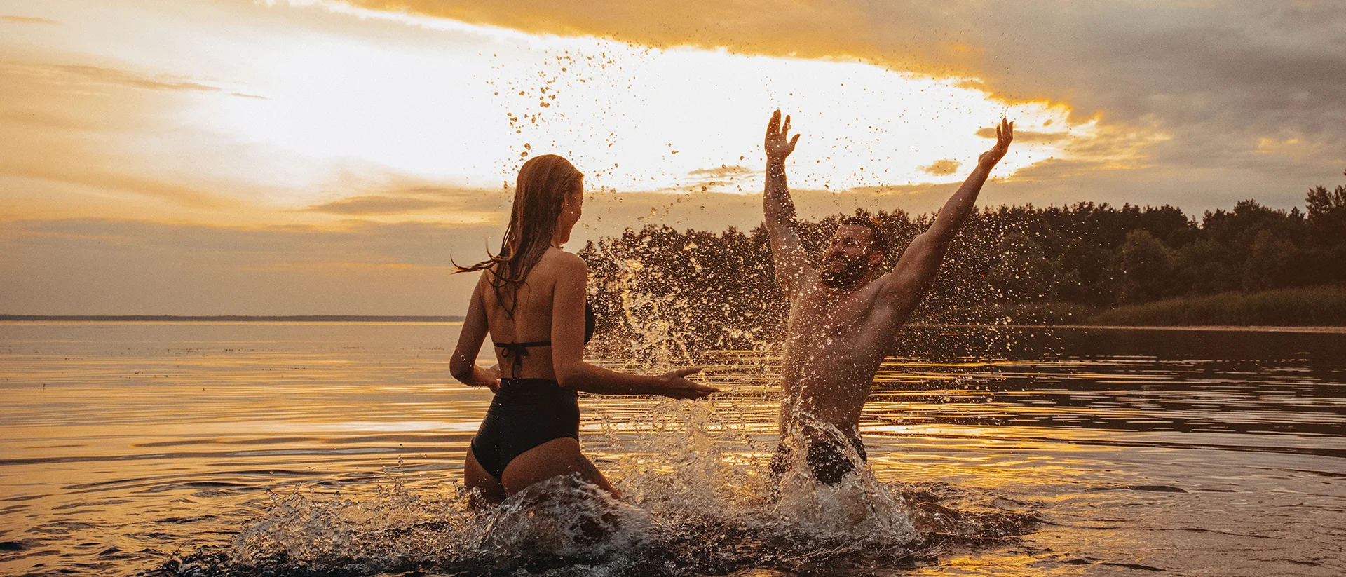 Couple plays in the water at Oneida Lake