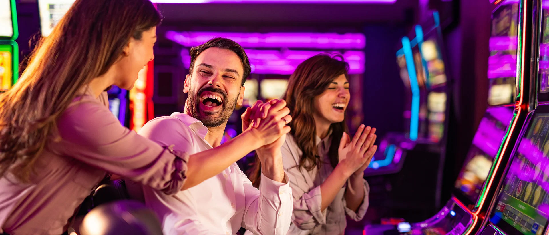 Friends playing slots at Point Place Casino Hotel